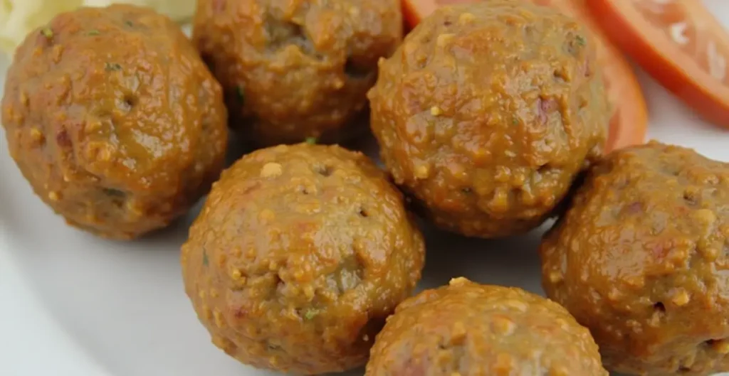 Sausage Balls Without Bisquick Recipe – golden-brown sausage balls served on a white plate with a side of dipping sauce.